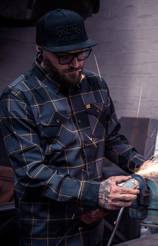 el lobo black and orange plaid flannel featured image worn by a guy grinding