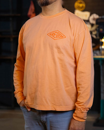 cross the line vintage orange long sleeved t-shirt with greasy in a diamond on the left chest