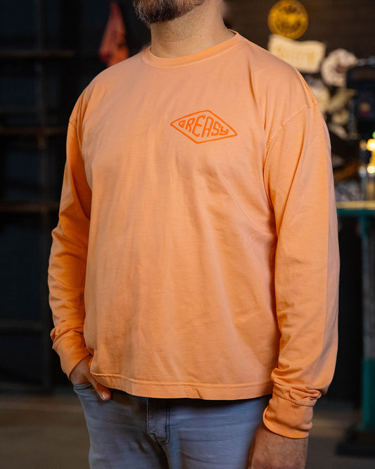 cross the line vintage orange long sleeved t-shirt with greasy in a diamond on the left chest
