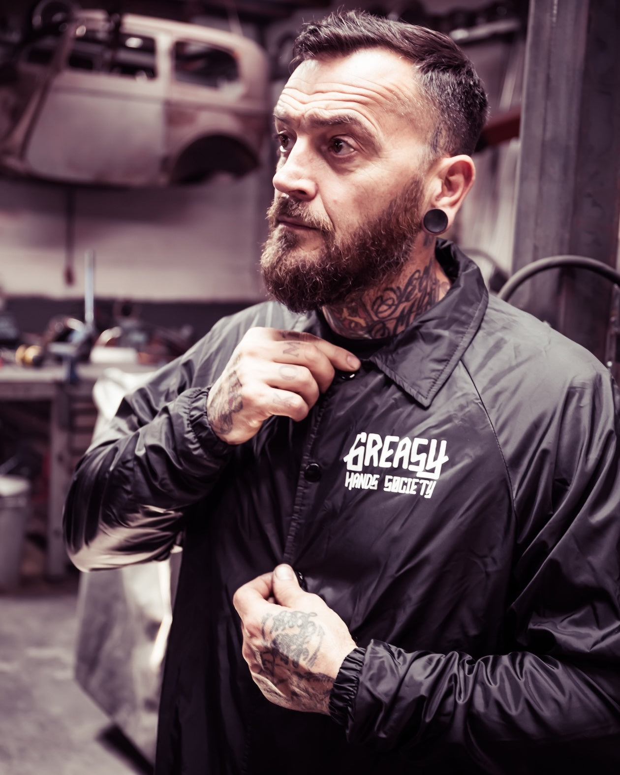 greasy hands society logo jacket front view on a model